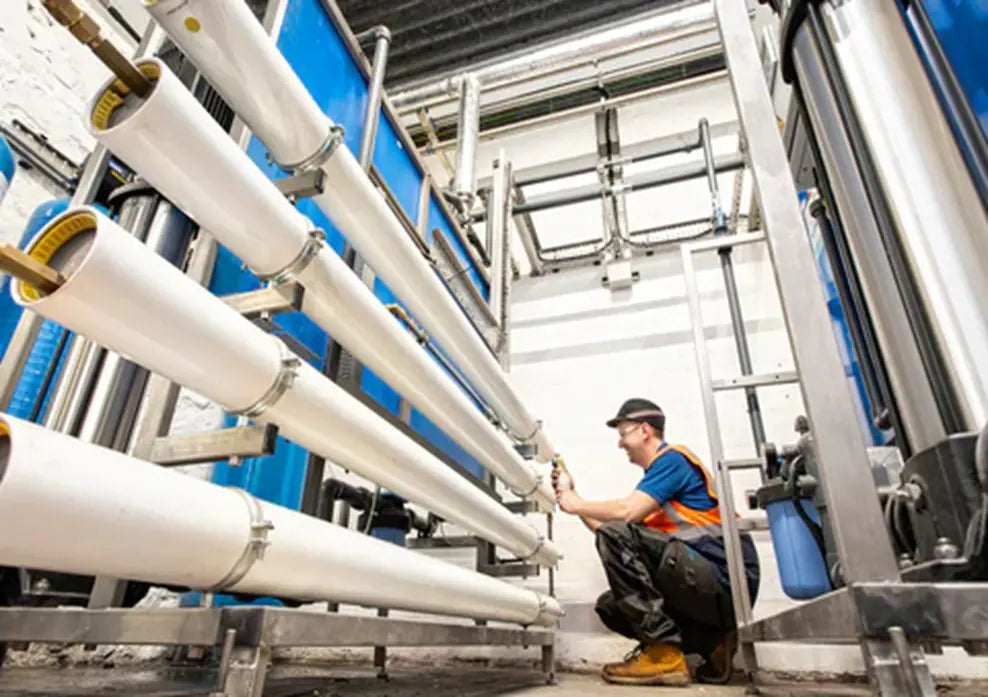 Engineer inspecting reverse-osmosis equipment